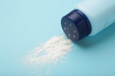 Baby powder on blue background. baby cosmetics. top viewの写真素材