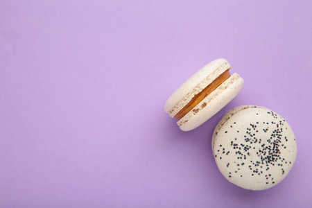 Cake macaron or macaroon on purple background. Space for text. top viewの写真素材