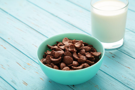 Set of various breakfast cereals with glass of milk on blue background. top viewの写真素材