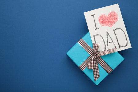 Happy Fathers Day banner template. Gift box with postcard I love dad. Happy Father's Day on dark blue background with copy space.の写真素材