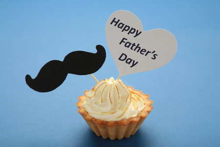 Father's day message with a cupcake with a mustache on dark blue background. top viewの写真素材
