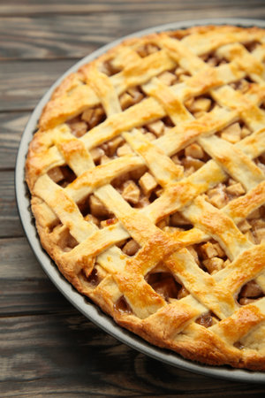 Homemade sweet American apple pie with sugar and cinnamon. Tart on brown wooden background. Top viewの写真素材