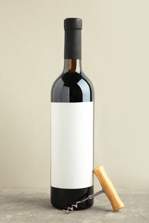 Bottle of wine with corkscrew on gray background. Vertical photo. Top viewの写真素材