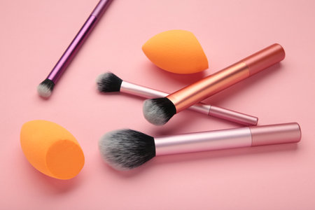 Makeup buffer brush and beauty makeup sponges on pink background. Beauty and makeup concept. Top viewの写真素材