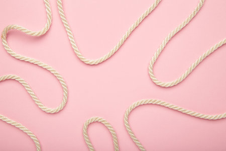 White wavy rope on pink background. Top viewの写真素材
