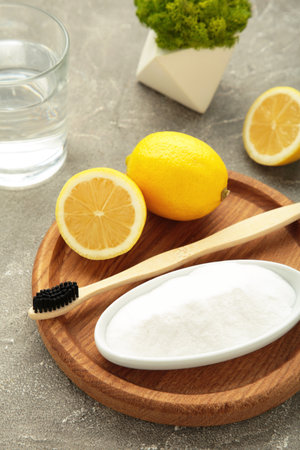 Toothbrush with lemon and baking soda on gray background. Vertical photo. Top viewの写真素材
