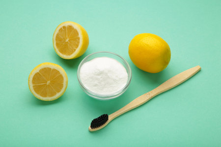 Wooden bamboo eco friendly toothbrushes, baking soda on mint background. Dental care and zero waste concept. Top viewの写真素材
