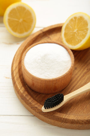 Toothbrush with lemon and baking soda on white background. Vertical photo. Top viewの写真素材