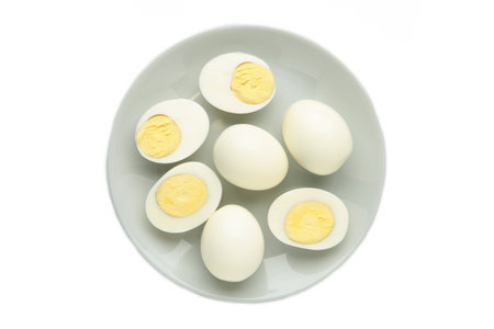 Boiled eggs on plate isolated on white background. Top view