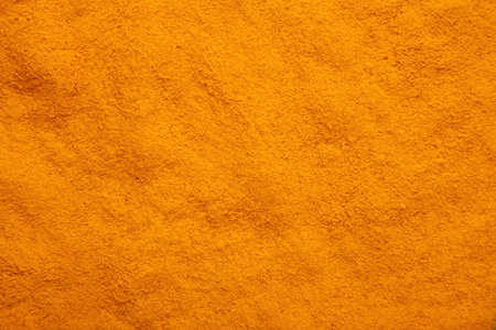 Turmeric powder background. Macro. Top view