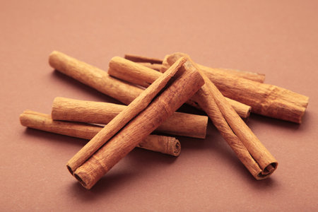 Cinnamon sticks on brown background. Top viewの写真素材