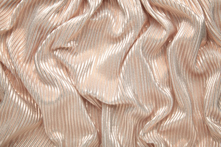 Beige brilliant texture. Cloth textile background. Top view. Space for text