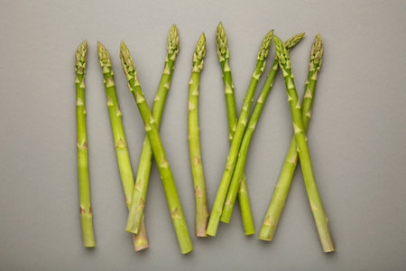 Fresh green asparagus on gray background. Healthy food concept. Vegan healthy food. Top viewの写真素材