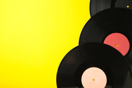 Gramophone vinyl records isolated on yellow background. Top viewの写真素材