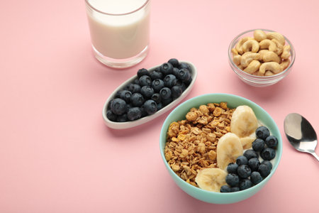 Oat raisin granola with fresh summer berries in a bowl, top view. Concept of healthy breakfast food