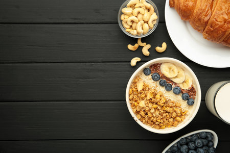 Healthy breakfast set on black background. Granola with fresh summer berries. Top viewの写真素材