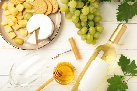 Wine tasting. Parmesan cheese with glass of wine on white background. Top viewの写真素材