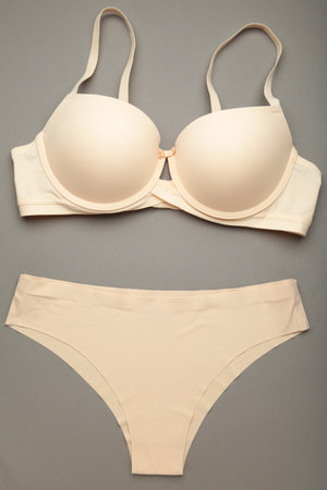 Stylish beige women's underwear on gray background, flat lay.の写真素材