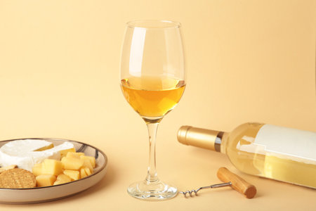 Wine tasting. Parmesan cheese with glass of wine on beige background. Cheese plate. Top viewの写真素材