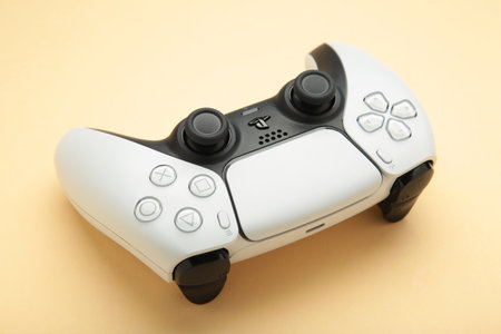 Mykolaiv, UKRAINE - July, 2024: New product from Sony, gamepad on beige background, game controller