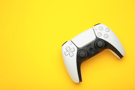 Mykolaiv, UKRAINE - July, 2024: New product from Sony, gamepad on yellow background, game controller