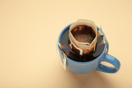 Drip coffee bag with ground coffee in cup. Making freshly brewed coffee at home. Top viewの写真素材