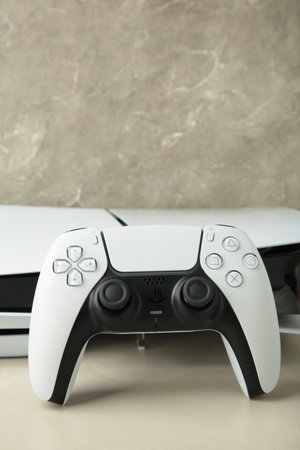 Mykolaiv, UKRAINE - July, 2024: White console and gamepad on light background