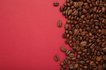 Roasted coffee beans on red background. Top viewの写真素材