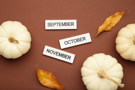 Calendar with September, October, November month with pumpkin on brown background.の写真素材