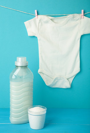 Laundry detergent products with white baby cloth and cotton flower on blue background.の写真素材