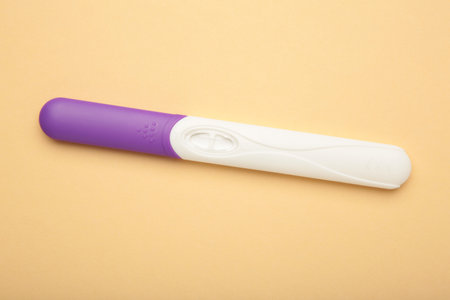 The new pregnancy test on beige background. Health care concept. Top viewの写真素材