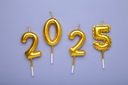 Holiday background Happy New Year 2025. Numbers of year 2025 made by gold candles on purple background. Top viewの写真素材
