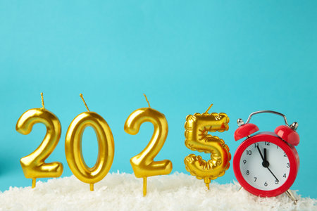 Candles 2025 with clock on blue background. Happy new year. Top viewの写真素材