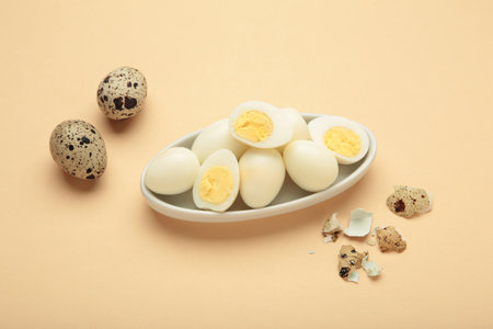 Boiled quail eggs on beige background. Top view