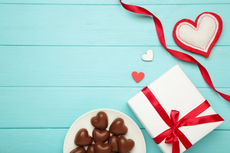 Valentine's day greeting card with gift, hearts chocolate sweets and letter on blue background. Top viewの写真素材