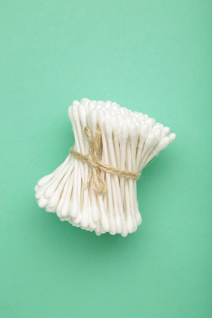 Cotton swabs on mint background. Top view
