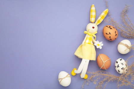 Creative composition with cute Easter bunny rabbit and egg on purple background. Creative art, minimal aesthetic look.の写真素材