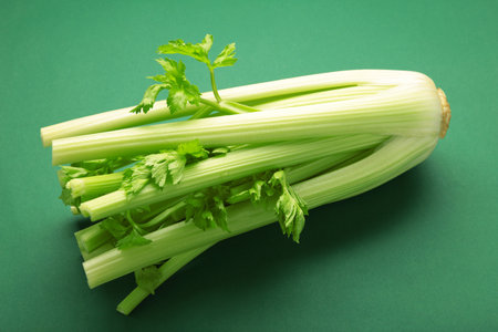 Fresh celery on dark green background. Top viewの写真素材
