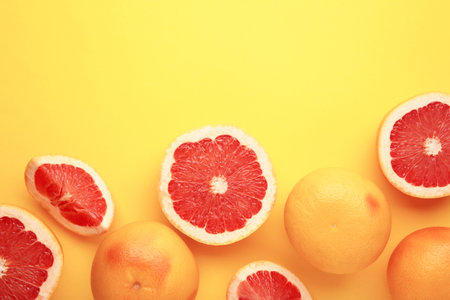 Fresh raw grapefruit on yellow background. Top viewの写真素材