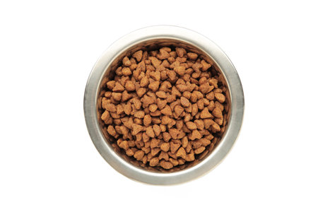Dry dog or cat food in a bowl isolated on a white background. Top view