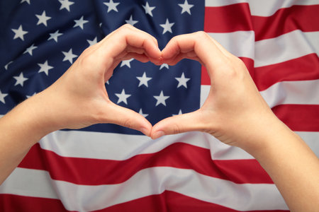 Independence day USA and memorial day or 4th of July. Hands showing heart and love against american flag. Top viewの写真素材