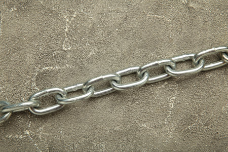 Iron chain of light metal on gray concrete background. Top viewの写真素材