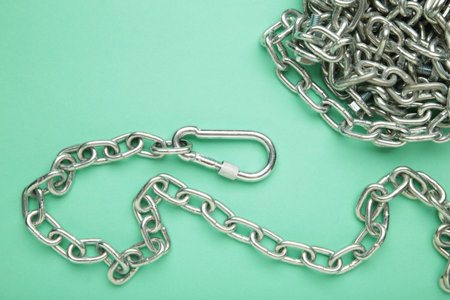 Iron chain of light metal on mint background. Top view