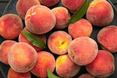 Ripe red peaches with green leaf. Macro photo. Top view