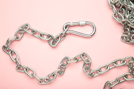 Iron chain of light metal on pink background. Top viewの写真素材
