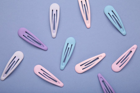 Set of pastel hairpins on purple background. Top viewの写真素材
