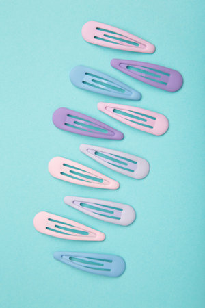 Set of pastel hairpins on blue background. Top viewの写真素材