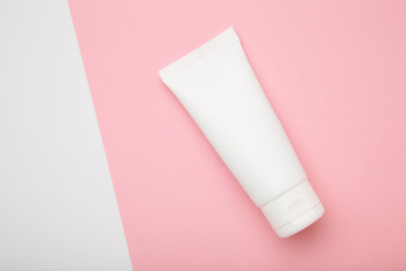 Mockup of medical skin care bottle cosmetic tube of beauty makeup facial on pink background. Top viewの写真素材