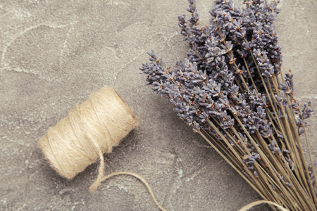 Lavender flowers on gray concrete background. Floral composition. Top view