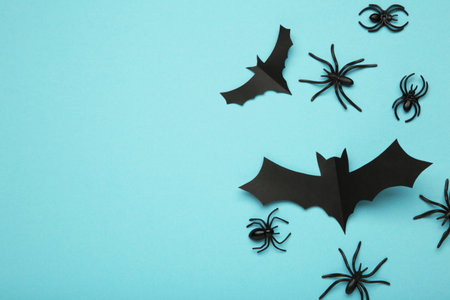 Halloween background with spiders as symbols of Halloween on the blue background. Top view